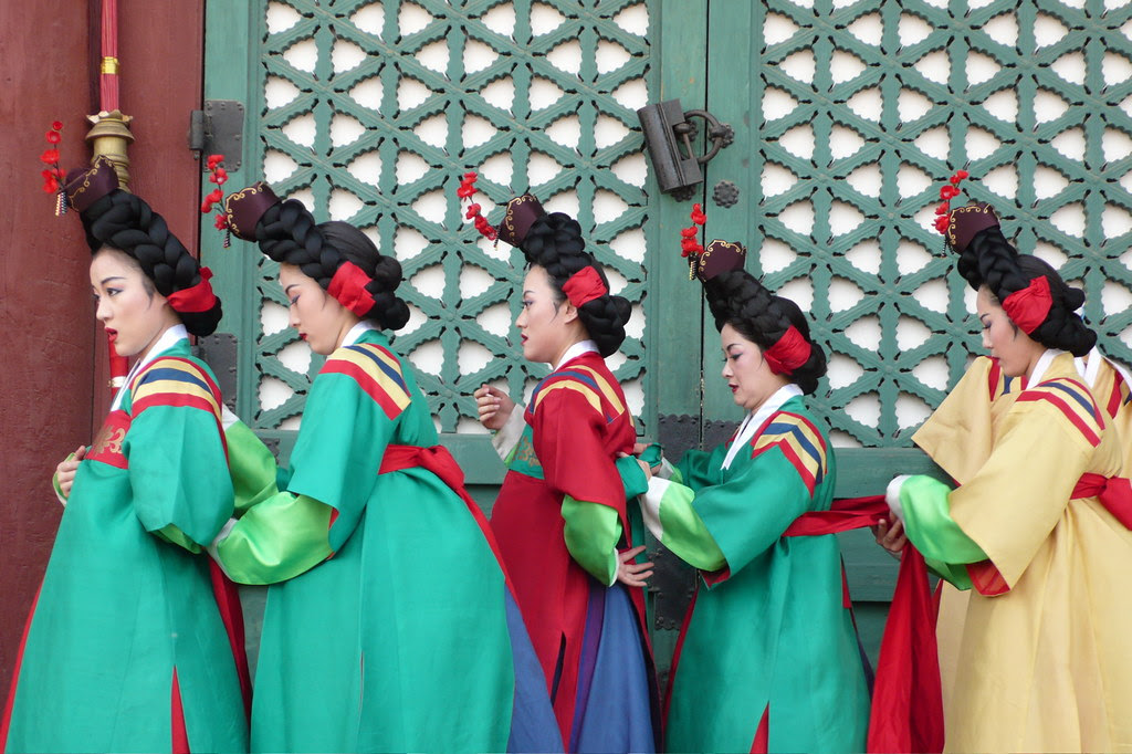 Dancers in Korean traditional dress preparing to go on stage