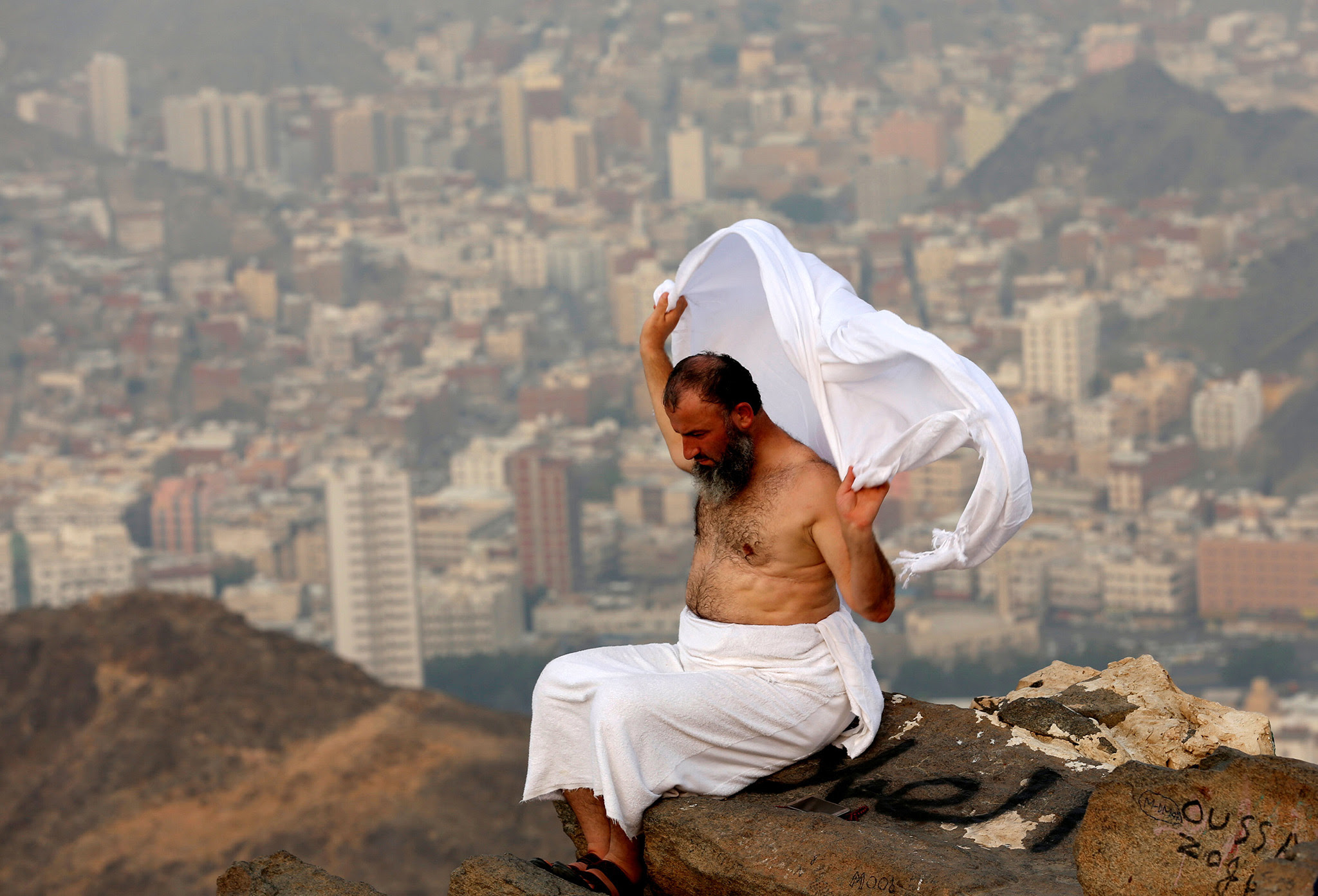 A Muslim pilgrim sits on the top of Mount Al-Noor, where Muslims believe Prophet Mohammad received the first words of the Koran through Gabriel in the Hera cave, ahead of the annual haj pilgrimage in the holy city of Mecca, Saudi Arabia September 7, 2016. REUTERS/Ahmed Jadallah