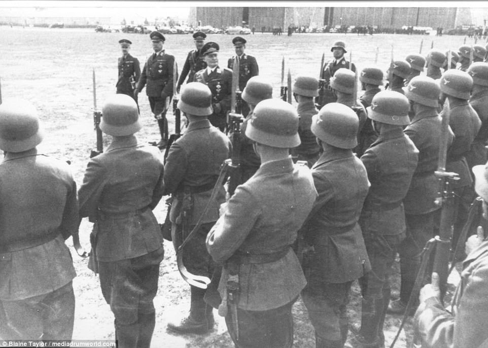 The VIPs review a Luftwaffe honor guard with rifles and bayonets at Present Arms on 26 March 1938 at Aspern Airport. From left to right: the reviewers are Löhr, Sperrle, Goering, and Bodenschatz, with the officer at center behind them unknown
