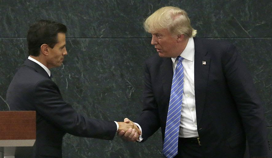 FILE - In this Aug. 31, 2016 file photo, Mexico's President Enrique Pena Nieto, left, and Republican presidential nominee Donald Trump shake hands after a joint statement at Los Pinos, the presidential official residence, in Mexico City. Before his swearing-in, Trump has already hurt Mexico's economy by pressuring automakers to shift factories out of Mexico and amid an uncertain economic outlook, the peso has plunged to all-time lows against the U.S. dollar. (AP Photo/Marco Ugarte, File)