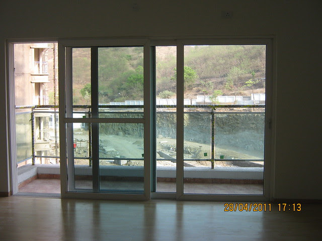 Sliding door and an attached balcony to living in Sangria Towers at Megapolis Hinjewadi Phase 3, Pune
