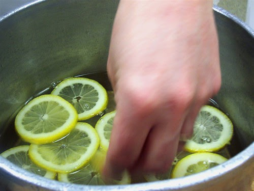 Lemon slices are added to boiled simple syrup
