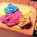 .crocheted flowers added to straw purse