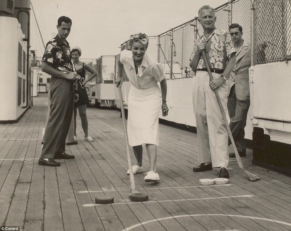 A man and woman enjoying a game of shuffleboard on the top deck of RMS Mauretania, which made its final voyage in 1965