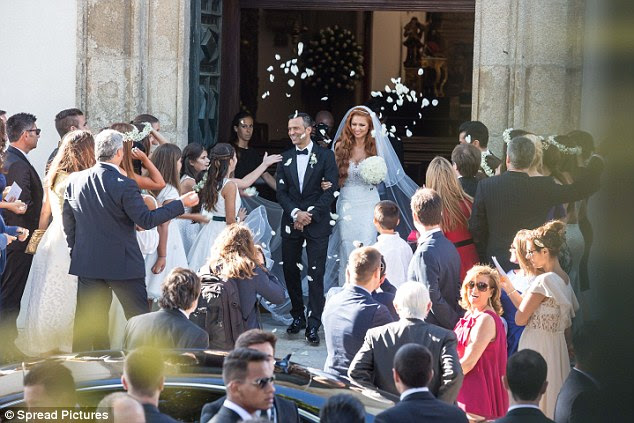 Confetti is thrown outside the Sao Joao Baptista church in Porto as well wishers greet the newly married duo