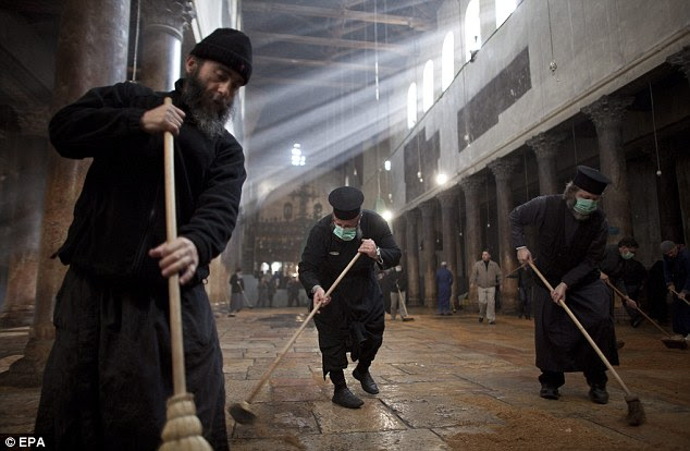 This is what they should have been doing: Greek Orthodox clean the floor of the Church of Nativity after the brawl 