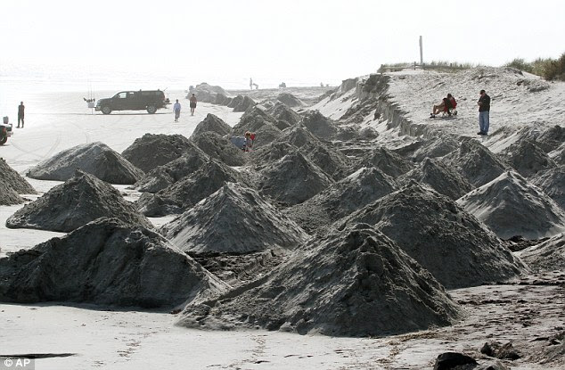 Breakage: Piles of sand were trucked onto the beach in North Wildwood, New Jersey in attempts to slow the waves