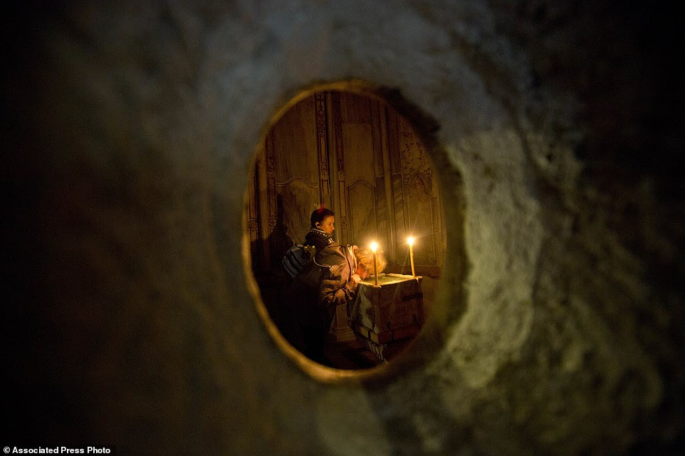 Faithful visit the renovated Edicule in the Church of the Holy Sepulchre, traditionally believed to be the site of the crucifixion of Jesus Christ, in Jerusalem's old city Monday, Mar. 20, 2017. A Greek restoration team has completed a historic renovation of the Edicule, the shrine that tradition says houses the cave where Jesus was buried and rose to heaven.