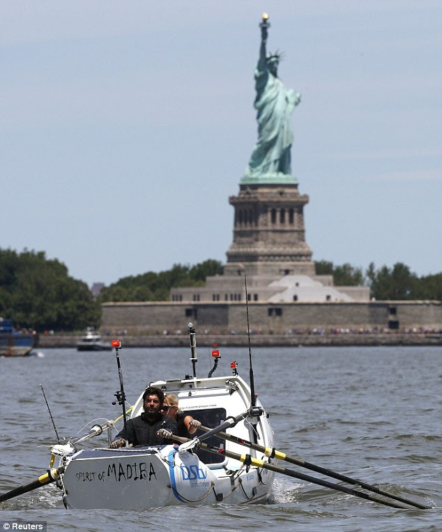 Arrivals: Manser and Geldenhuys row past the Statue of Liberty on Friday afternoon