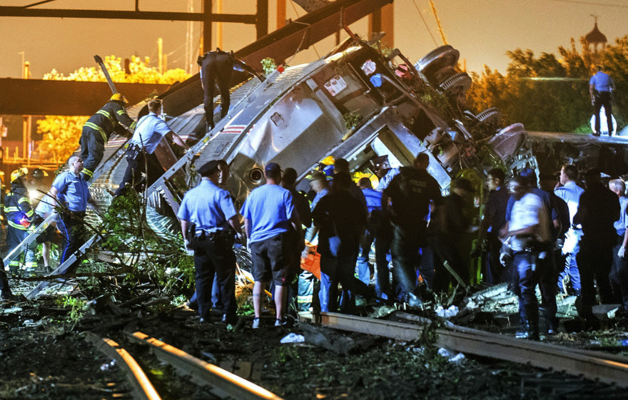 Image: Rescue workers climb into the wreckage of a crashed Amtrak train in Philadelphia