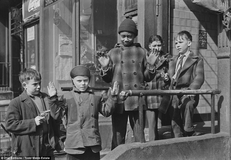 Pals: This photograph, called 123rd Street (Boys with Toy Gun) shows a black child and white friends playing in Harlem. Webb's writings show how he despised racism - describing seeing 'Whites Only' signs on a visit to the segregated South 'hard to take'