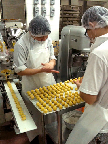 The round pineapple tarts are finished by hand