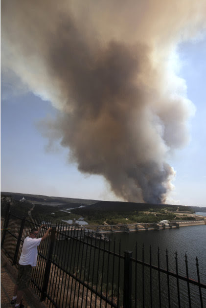 Smoke rises from a wildfire at Possum Kingdom Lake, Texas, Wednesday, Aug. 31, 2011. The wildfire that swept through the Possum Kingdom Lake neighborhood, one of several burning in Texas and Oklahoma,