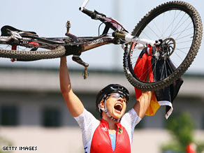Sabine Spitz of Germany celebrates her victory in the women's mountain bike on Saturday.