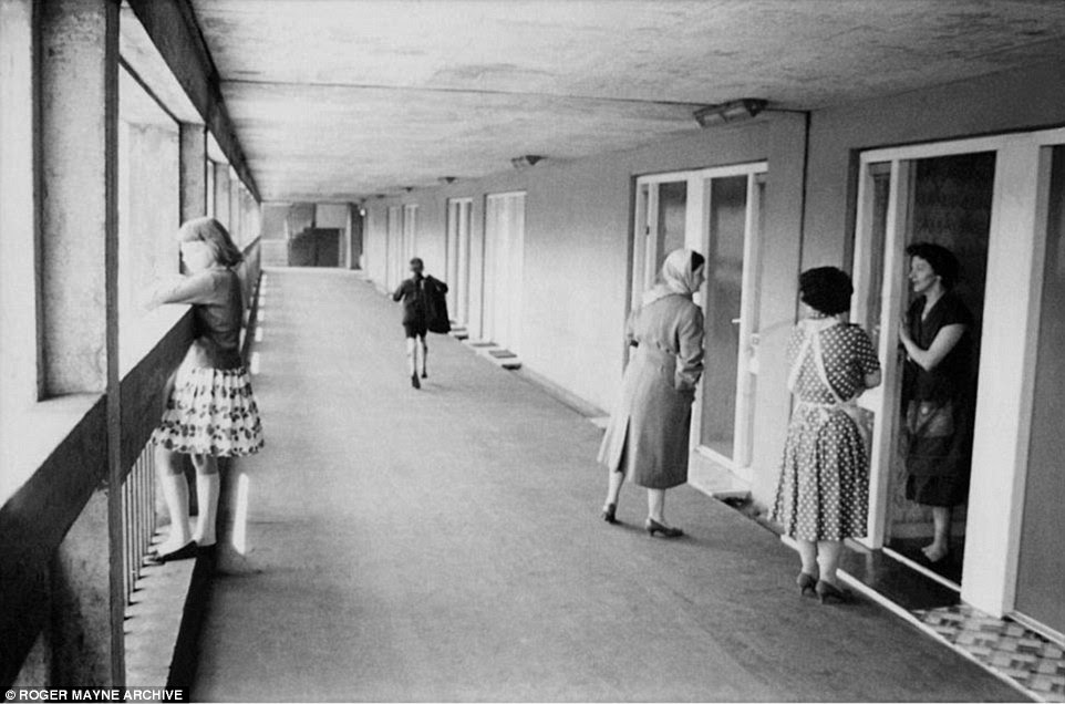 A group of women chat in the doorway of a flat in the Park Hills Estate in Sheffield