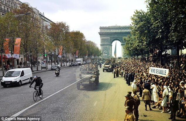 People line the streets in support for allied troops as they make their way through Paris near the famous Arc de Triomphe