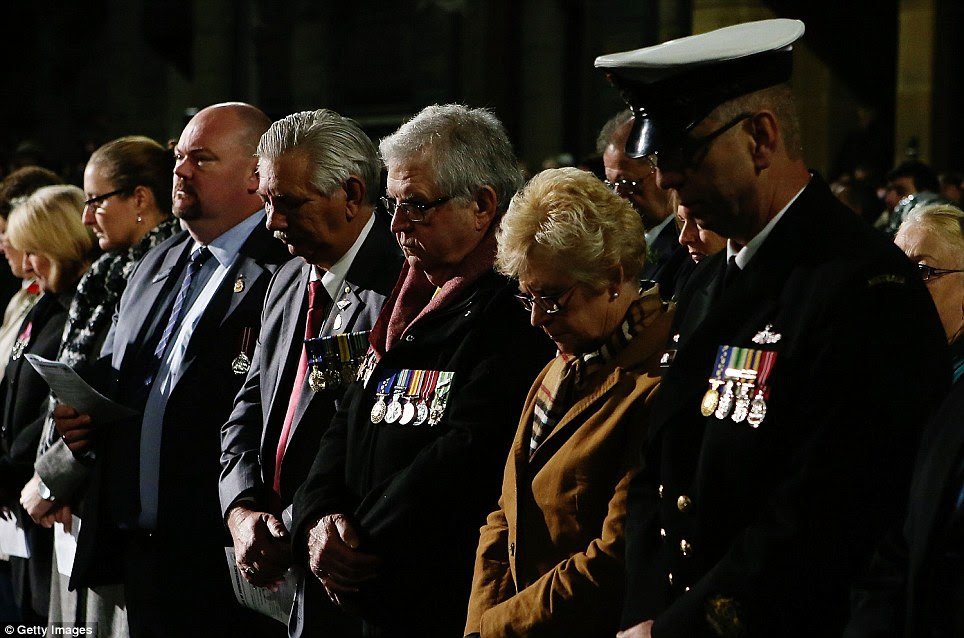 In silence: People pay their respects at the Anzac Cenotaph during the Anzac Dawn Service at the Martin Place Cenotaph today in Sydney, Australia