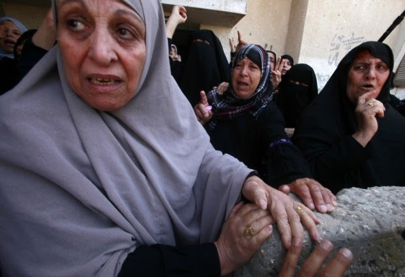 Palestinian relatives of Khaled Sha'at, a member of an armed Palestinian faction, and his two-year-old son Malek mourn during their funeral in Rafah