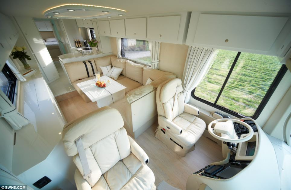 Comfort: The driver has plenty of rooms to stretch his legs as he sits behind the wheel, while the bedroom area (pictured behind the front seats) converts into a TV lounge 