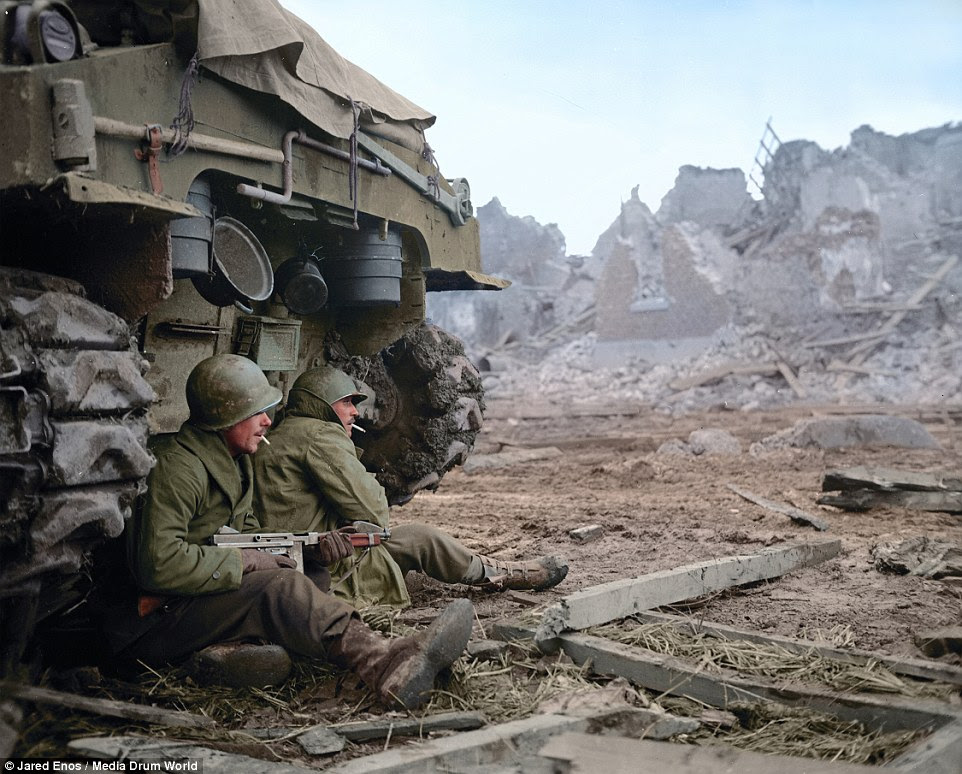 Glimpse of the past: Two American soldiers shelter behind their tank on December 11, 1944, in Geich, near Dren, Germany
