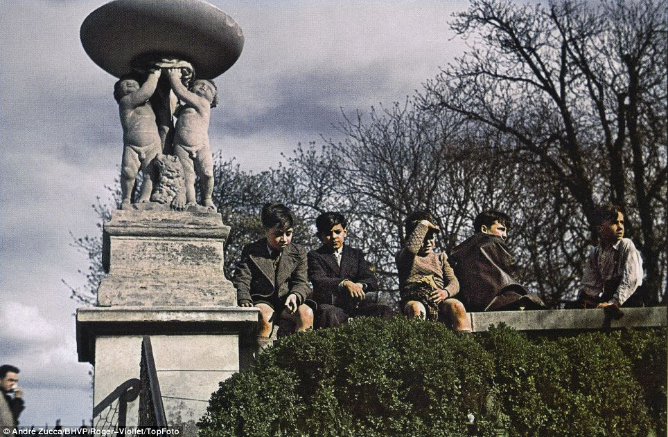 Boys sit on a park wall: After Paris fell to the Nazis on June 14, 1940, Zucca was commissioned to work for the Signal the following year to portray the occupation in a positive light