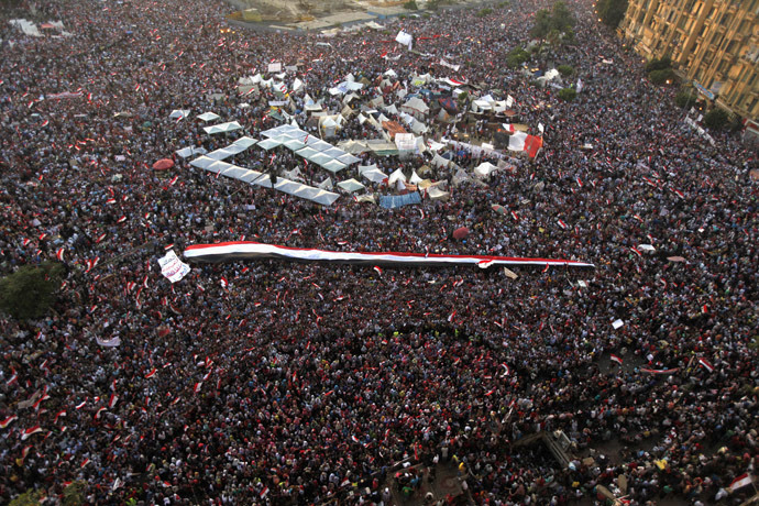 A large Egyptian flag is seen as protesters opposing Egyptian President Mohamed Morsi shout slogans against him and Brotherhood members during a protest at Tahrir Square in Cairo June 30, 2013. (Reuters)