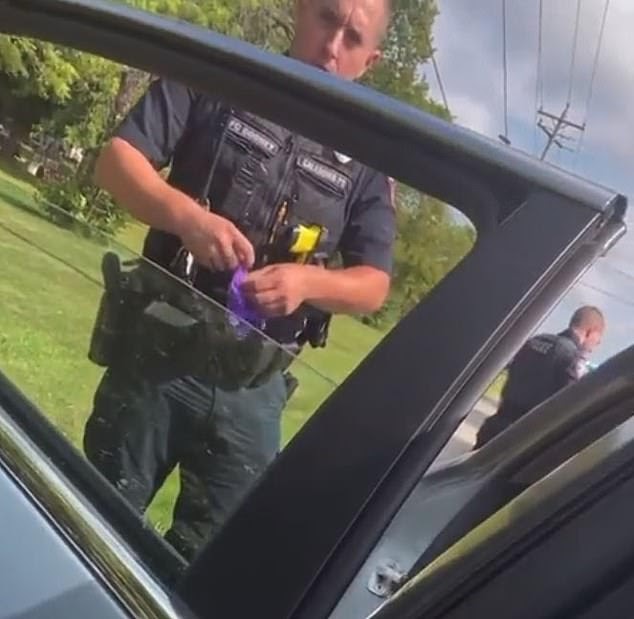 Wisconsin police insist officer WASN'T planting evidence after viral ...