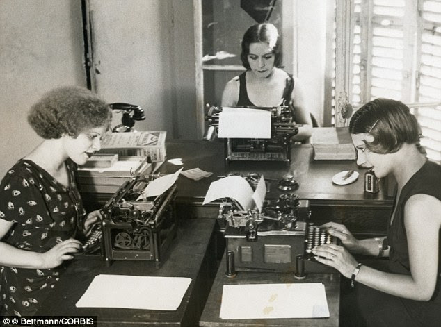 Hard at work: Three women cram into a tiny office space 