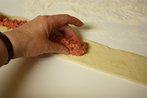 Placing meat on dough