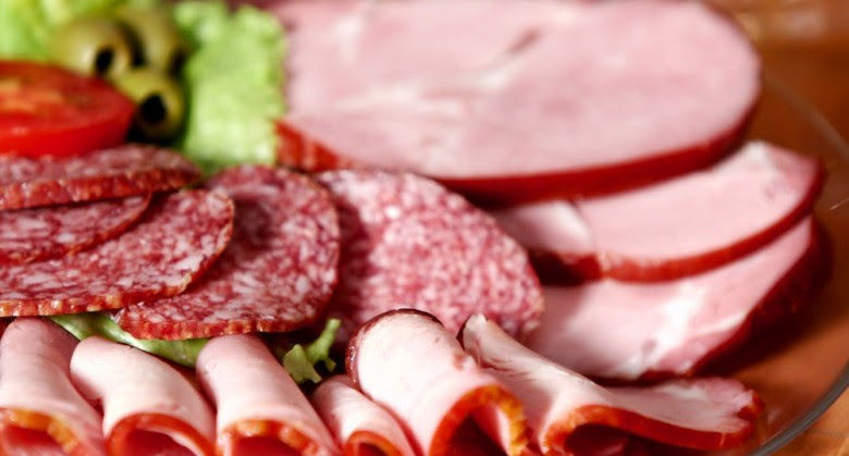 Dish with cutting sausage and cured meat on a celebratory table.