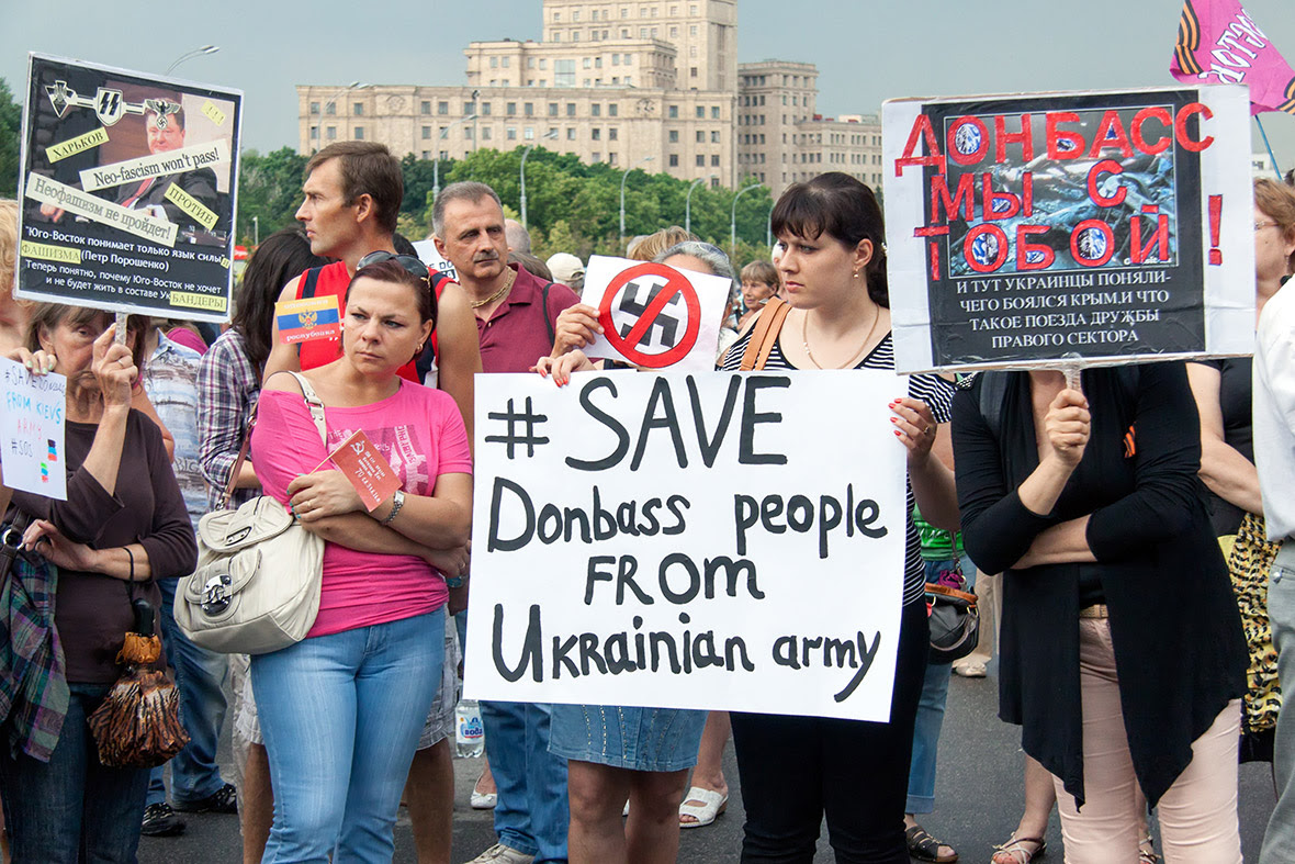 Pro-Russian supporters hold placards reading 