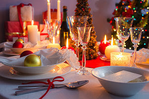 Christmas dishware on the white and red table