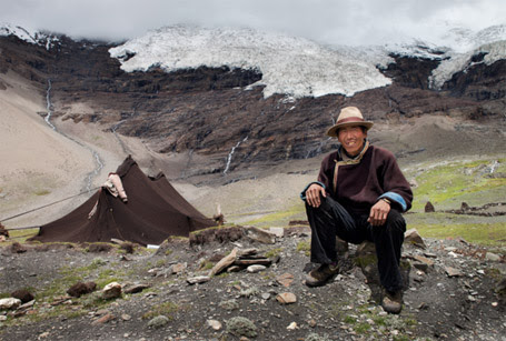 Phil Borges|Puchen, age 37, remembers the Nojin-Kangtsang glacier reached his tent when he was a boy. Shigatse Prefecture