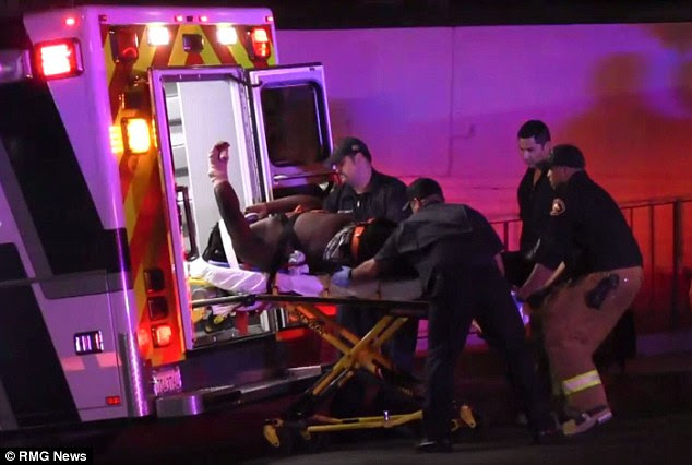 Injured: Another victim is transferred into an ambulance in a stretcher