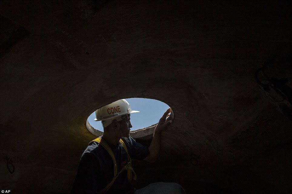 A worker looks outside from inside the head of the Christ Redeemer statue in Rio de Janeiro