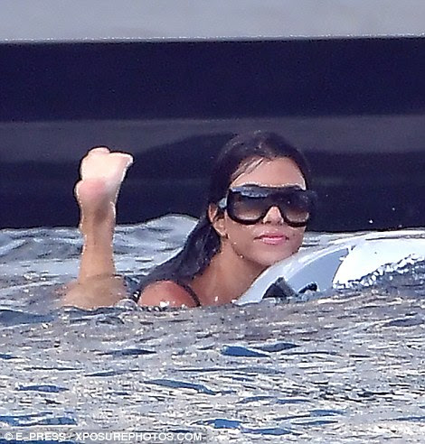 Always stylish: Kourtney kept her oversized sunglasses on as they frolicked in the water