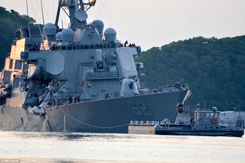 Crashed: The starboard side of the USS Fitzgerald is clearly manged in this picture taken on Saturday as the ship returned to base