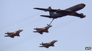 Israeli F-15 fighter jets refuel during an air show at the graduation ceremony of Israeli pilots in the Hatzerim air force base in the Negev desert near the southern Israeli city of Beersheva on June 30, 2011