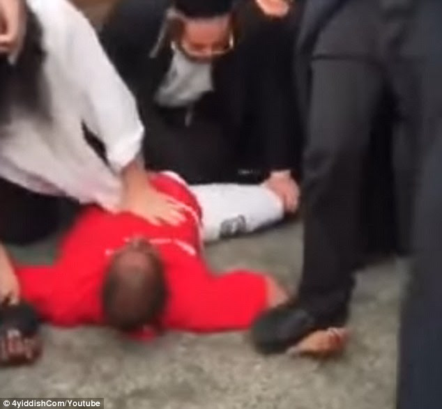 The group of men quickly tackled him and pinned his arms and legs to the concrete until police arrived. He allegedly stole a child's scooter from outside the synagogue