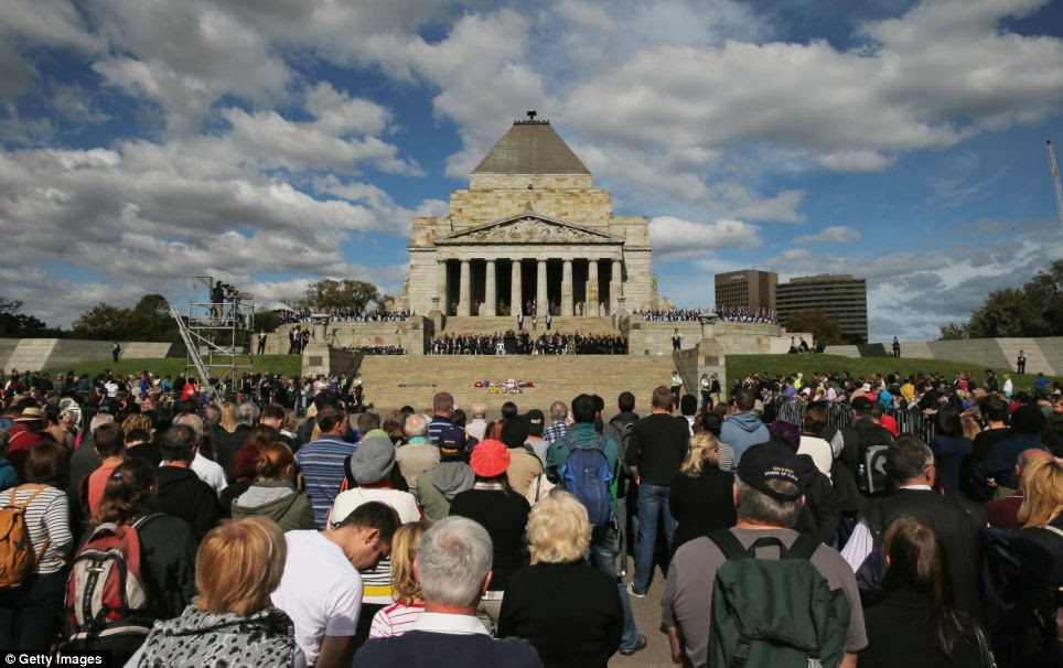Gathering: Crowds of people look on after the annual Anzac Day march at the Shrine of Remembrance in Melbourne