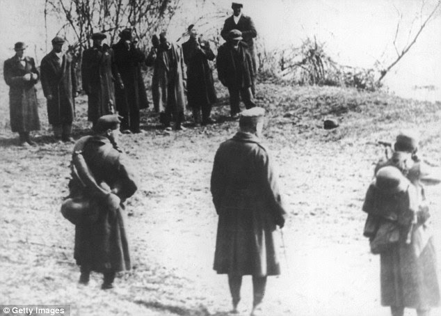 Executions: German soldiers line up and execute a group of Jewish men by the banks of the Danube in Hungary
