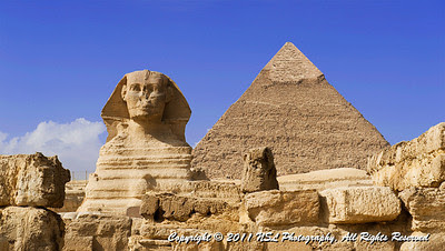 The Great Sphinx of Giza in the foreground with the Pyramid of Khafre in the background at the Giza Necropololis. Note the prominent display of casing stones at the apex of the Pyramid of Khafre.