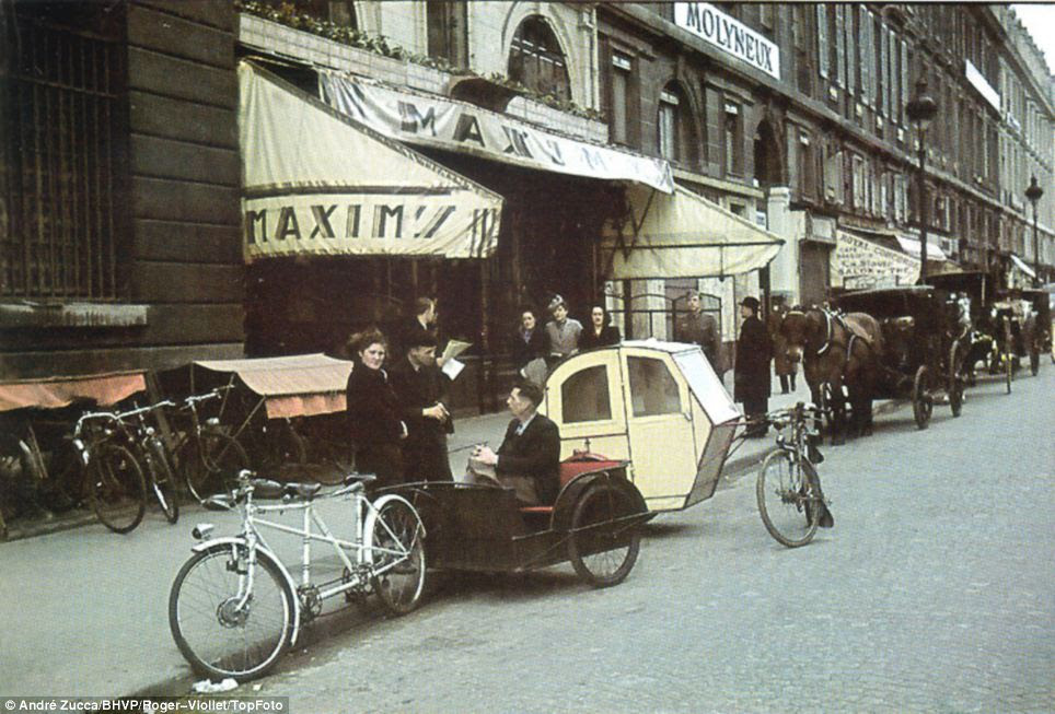 Not yet modern: Bicycles are joined in this picture by the even then anachronistic sight of a horse-drawn carriage