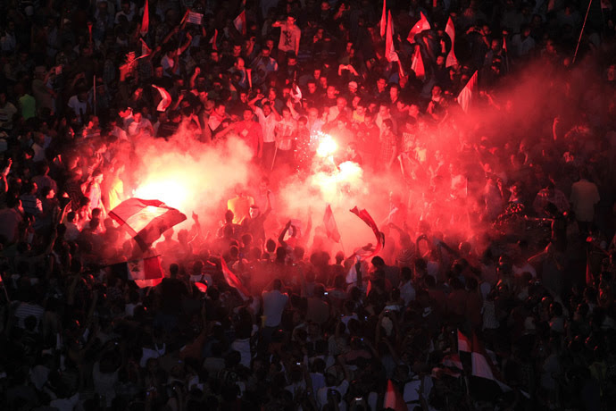 Protesters opposing Egyptian President Mohamed Morsi gather near a lit a flare during a protest at Tahrir Square in Cairo June 30, 2013. (Reuters)