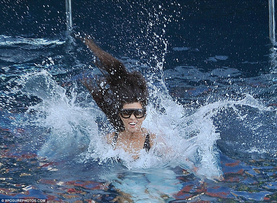 Tough landing: Kourtney made a big splash as she leaped into the ocean