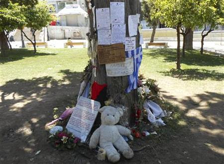 Flowers, toys and notes are seen at the site where pharmacist Dimitris Christoulas shot himself in the head because of poverty brought on by the crisis that has put millions out of work, in Athens' Syntagma square April 27, 2012. REUTERS/Erik Kirschbaum