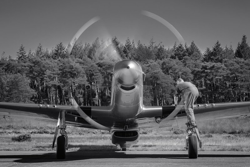 Crew Chief climbing a P-51 Mustang at the 2012 Zoersel PhotoFlying days Crew Chief climbing a P-51 Mustang at the 2012 Zoersel PhotoFlying days