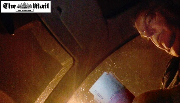 Caught on camera: The Rev Paul Flowers was filmed counting money for a drugs deal