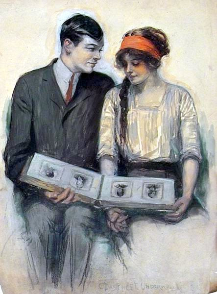 Young Couple Looking At Photo Album Young Couple Looking At Photo Album