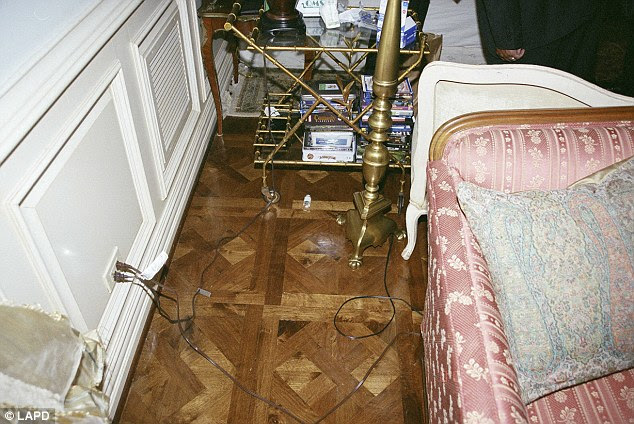 Battle: Empty bottle lie on the floor under a nightstand in Jackson's bedroom which holds stacks of DVDs